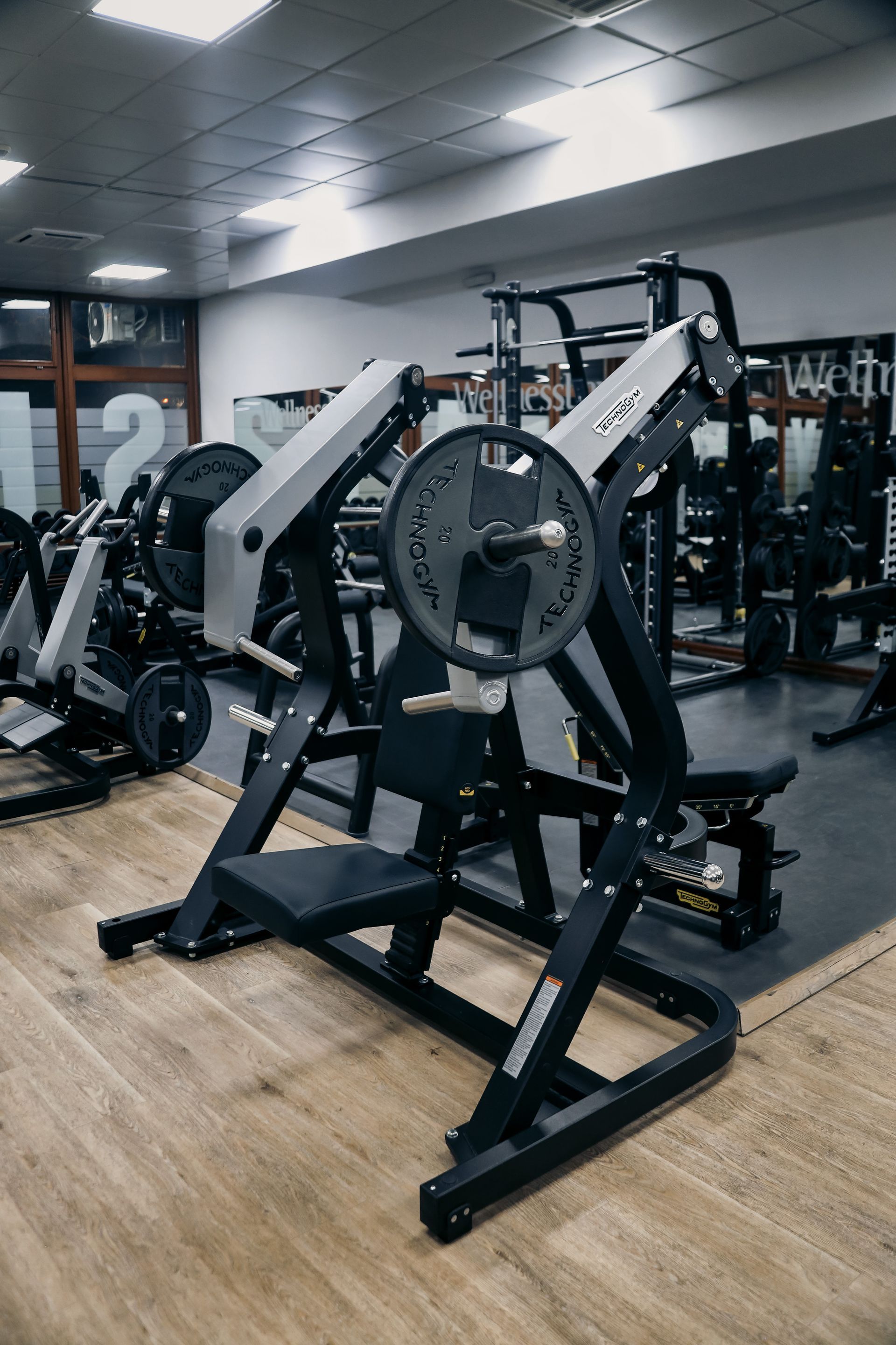 a gym with a lot of exercise equipment on the floor .
