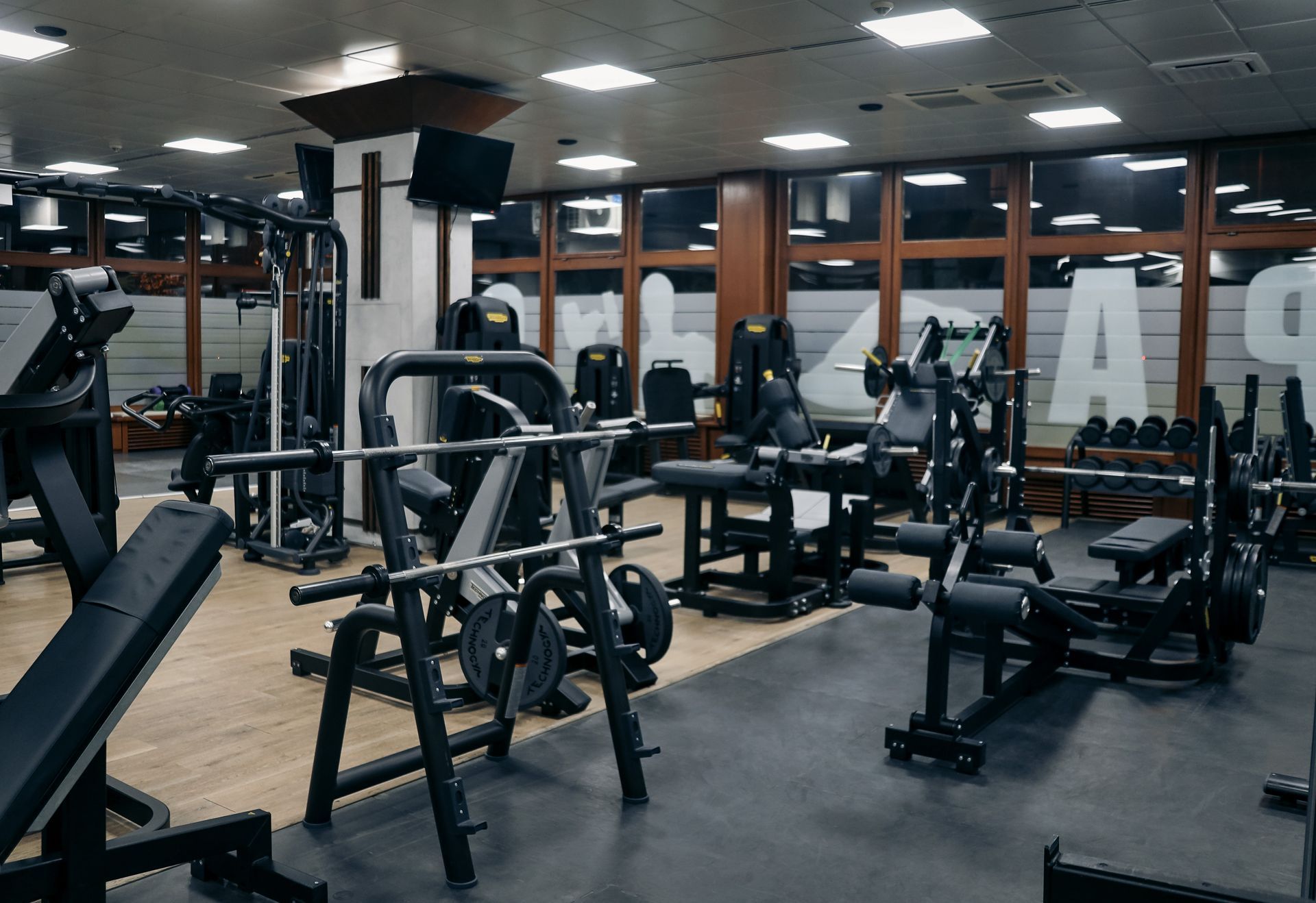a large empty gym with a lot of exercise equipment .