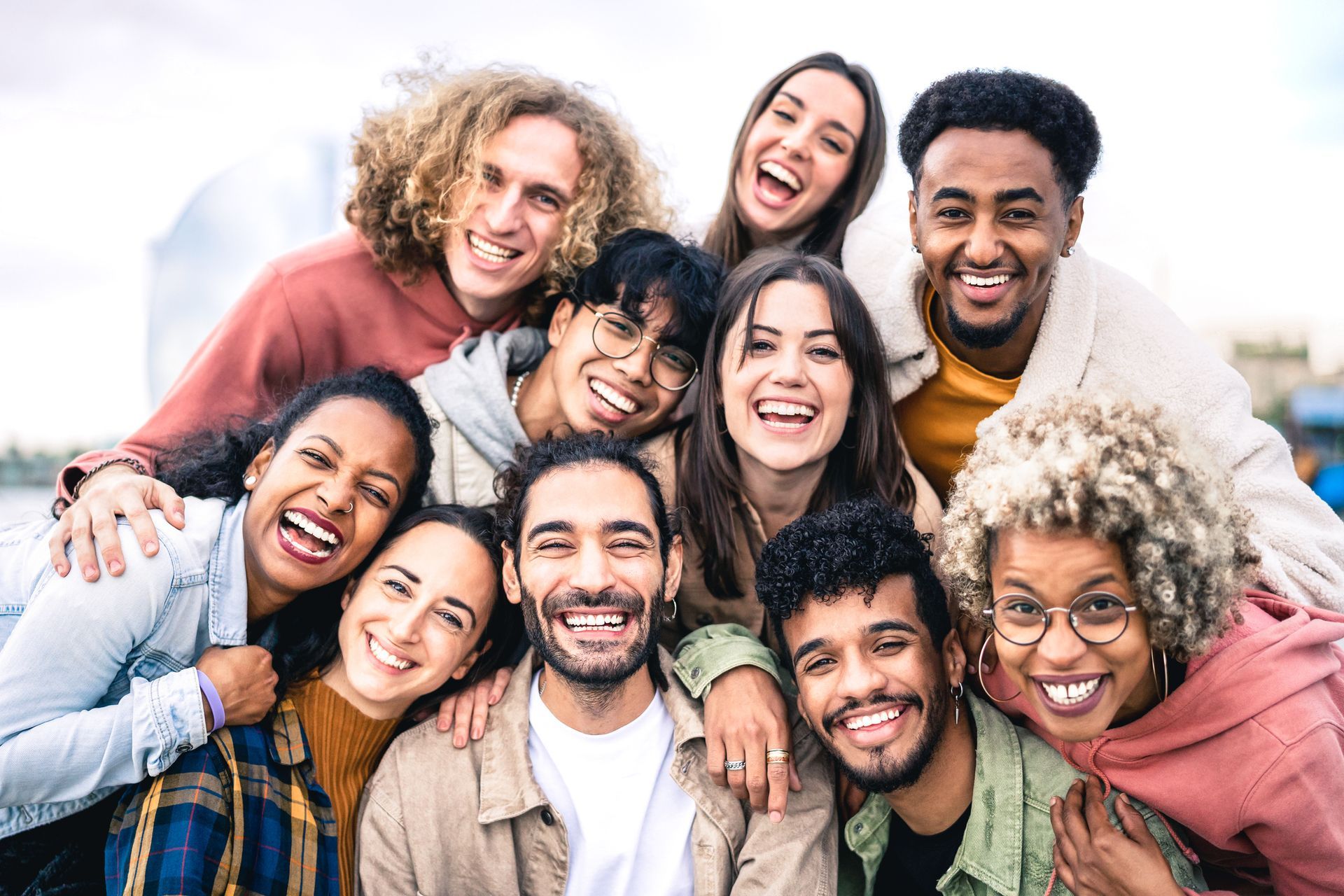 A group of young people are posing for a picture together and smiling.