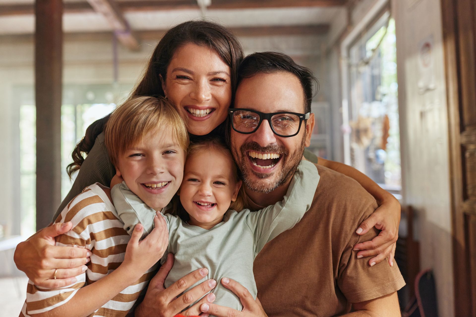 A family is posing for a picture together in a living room.