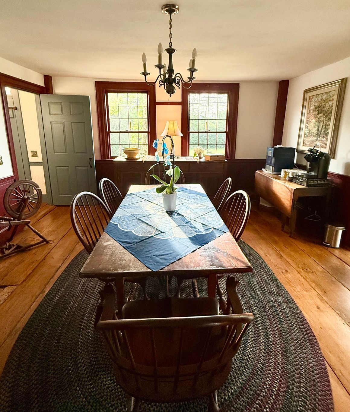 A dining room with a table and chairs and a rug