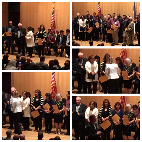 A group of people standing in front of an american flag
