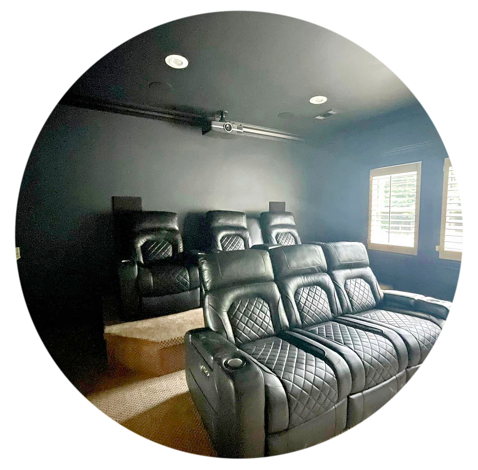 a theater room with seating projector and windows