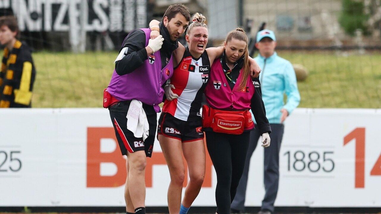 St Kilda AFLW Player Injured, supported by medical staff, injured on a sports field.