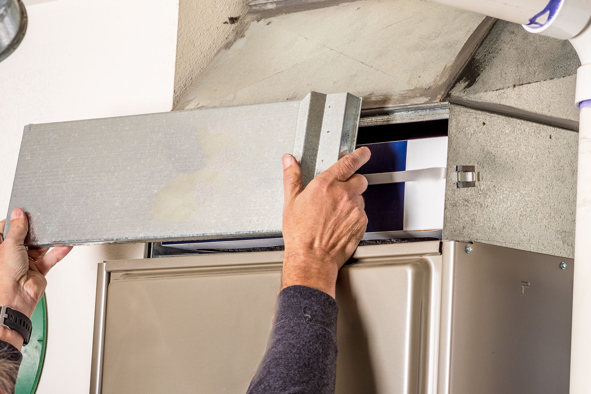 Technician inspecting an old residential furnace