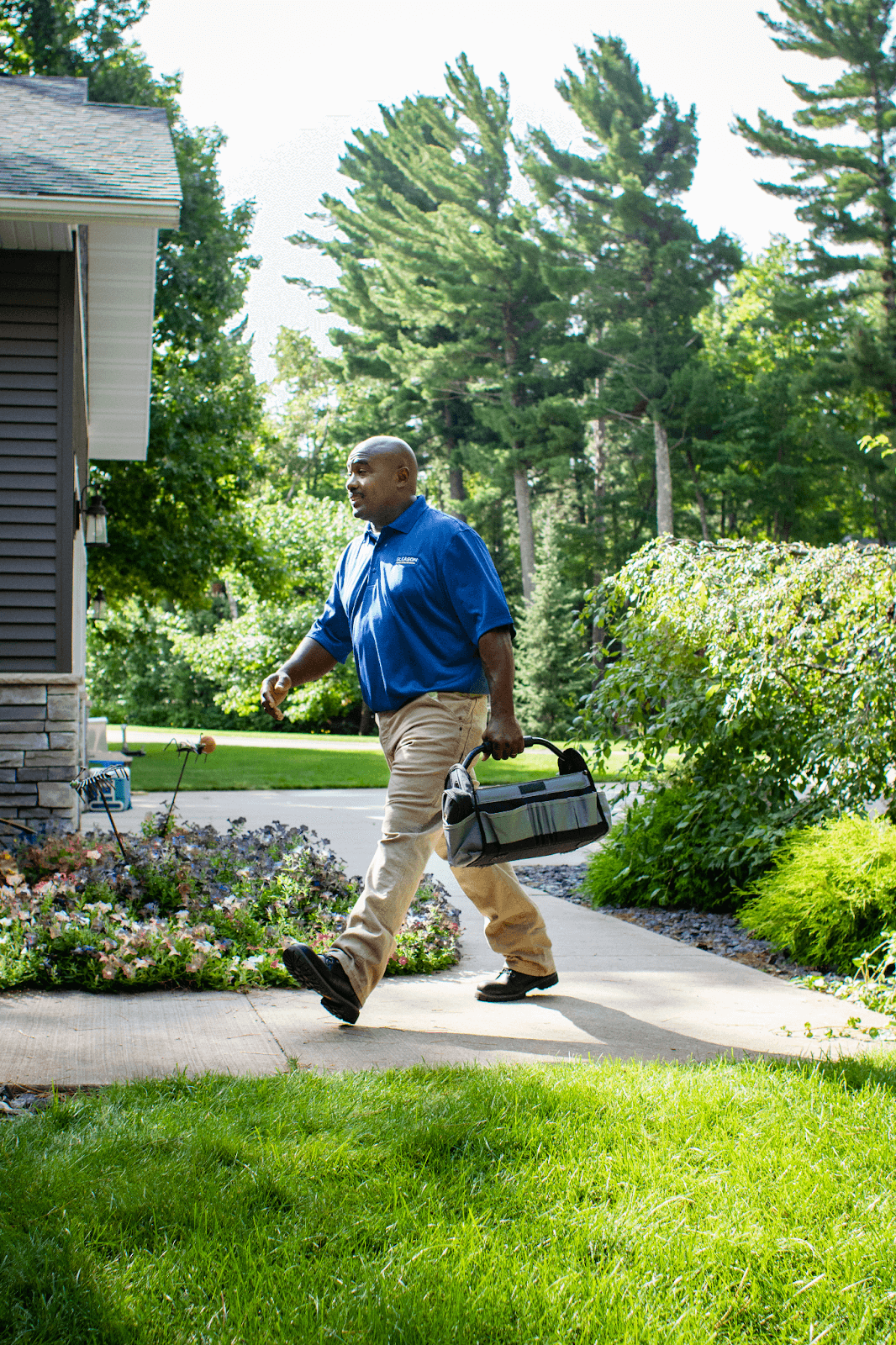 A man is walking to do Heat Pump Replacement & Repair