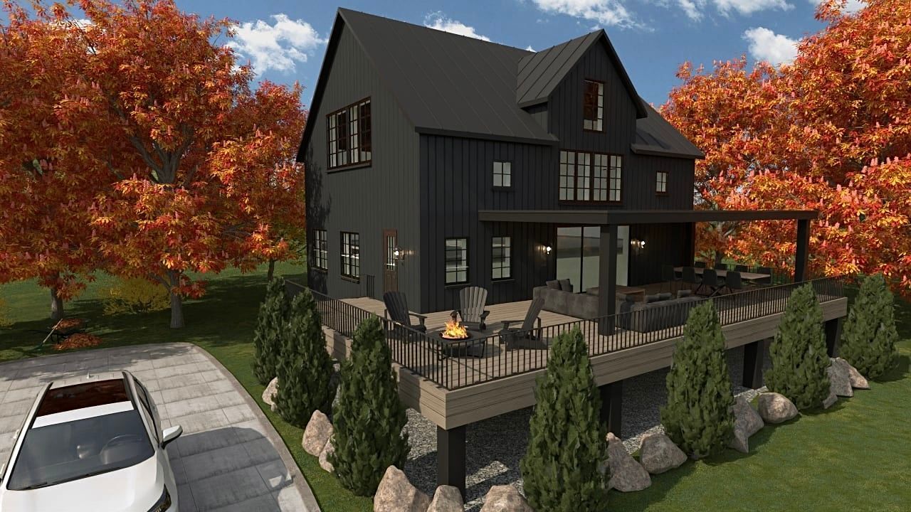 Une maison noire avec une voiture blanche garée devant.