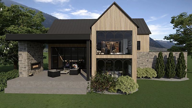 Une maison avec beaucoup de fenêtres et une cheminée dans l'arrière-cour.