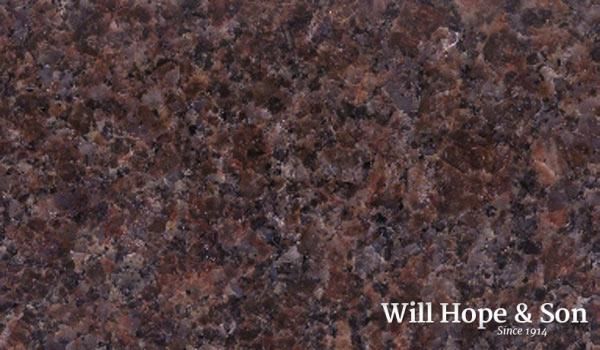 A close up of a brown granite counter top with the words will hope & son written on it.