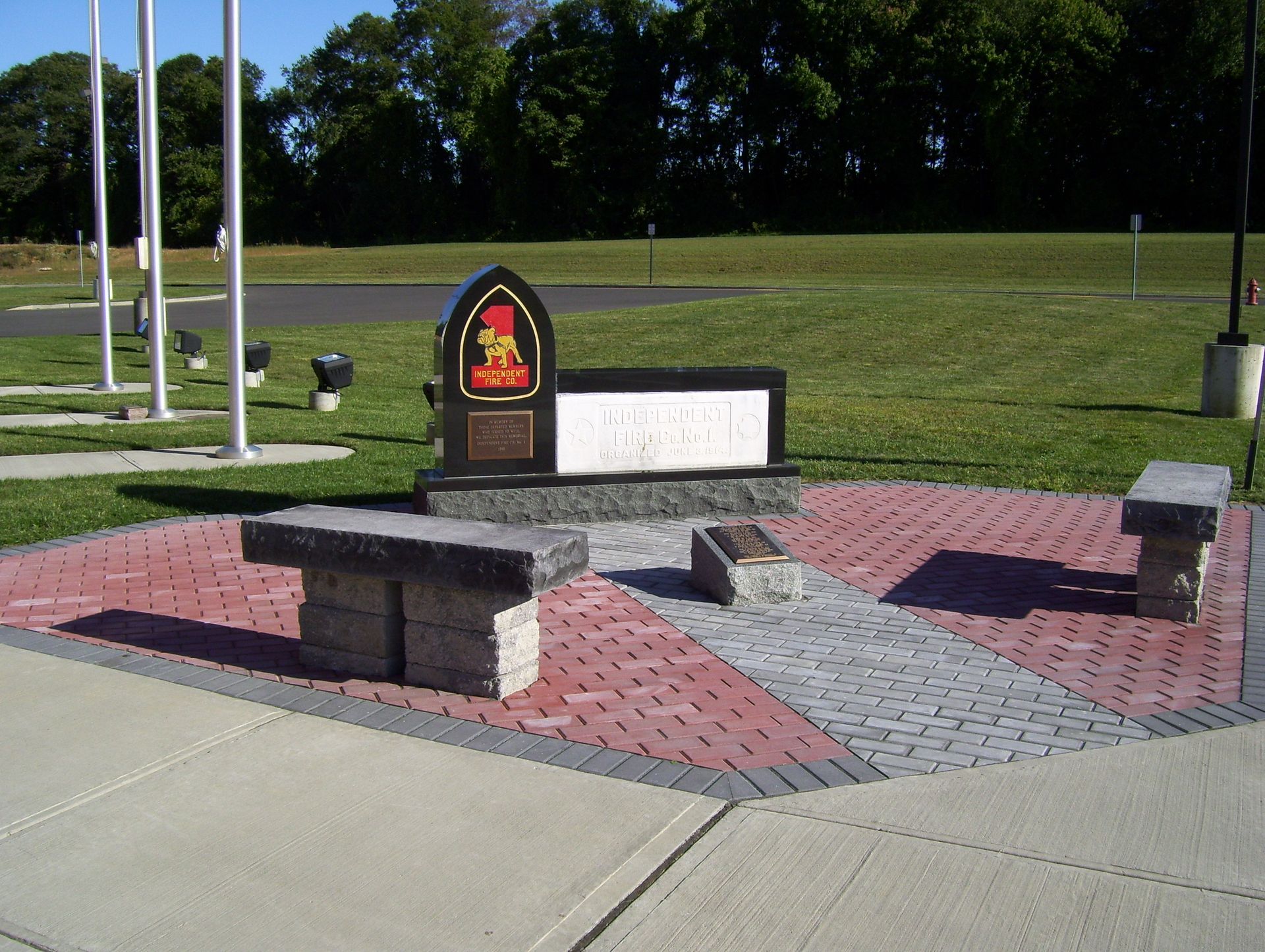 A brick walkway with a memorial in the middle of it