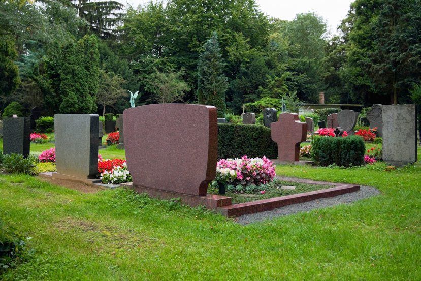 A cemetery filled with lots of graves and flowers.