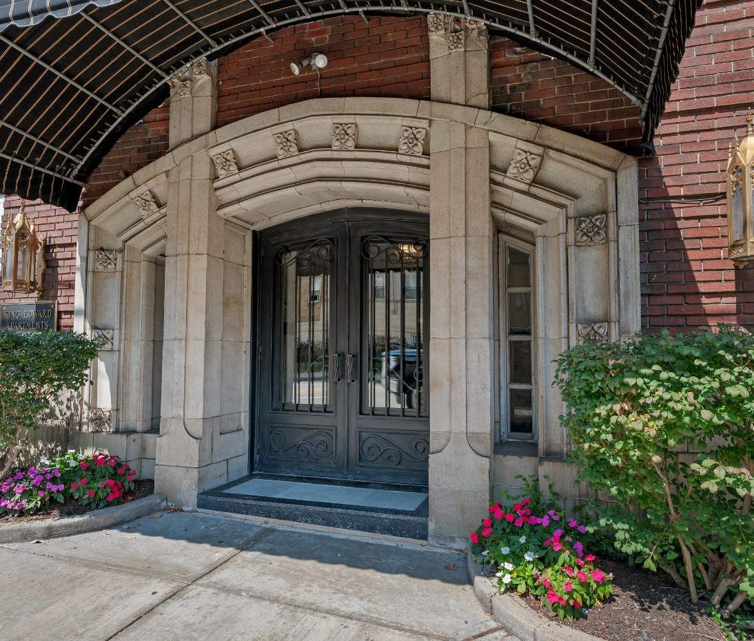 The entrance of a Pittsburgh property by Sterling Land, showcasing a decorative arched doorway with double doors.