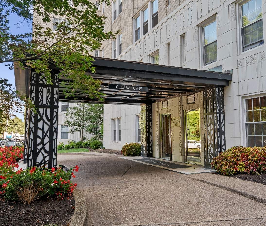 A covered walkway leading to a Pittsburgh property managed by Sterling Land entrance with double doors.