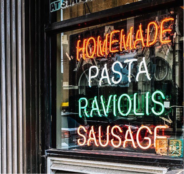 a neon sign that says homemade pasta raviolis sausage