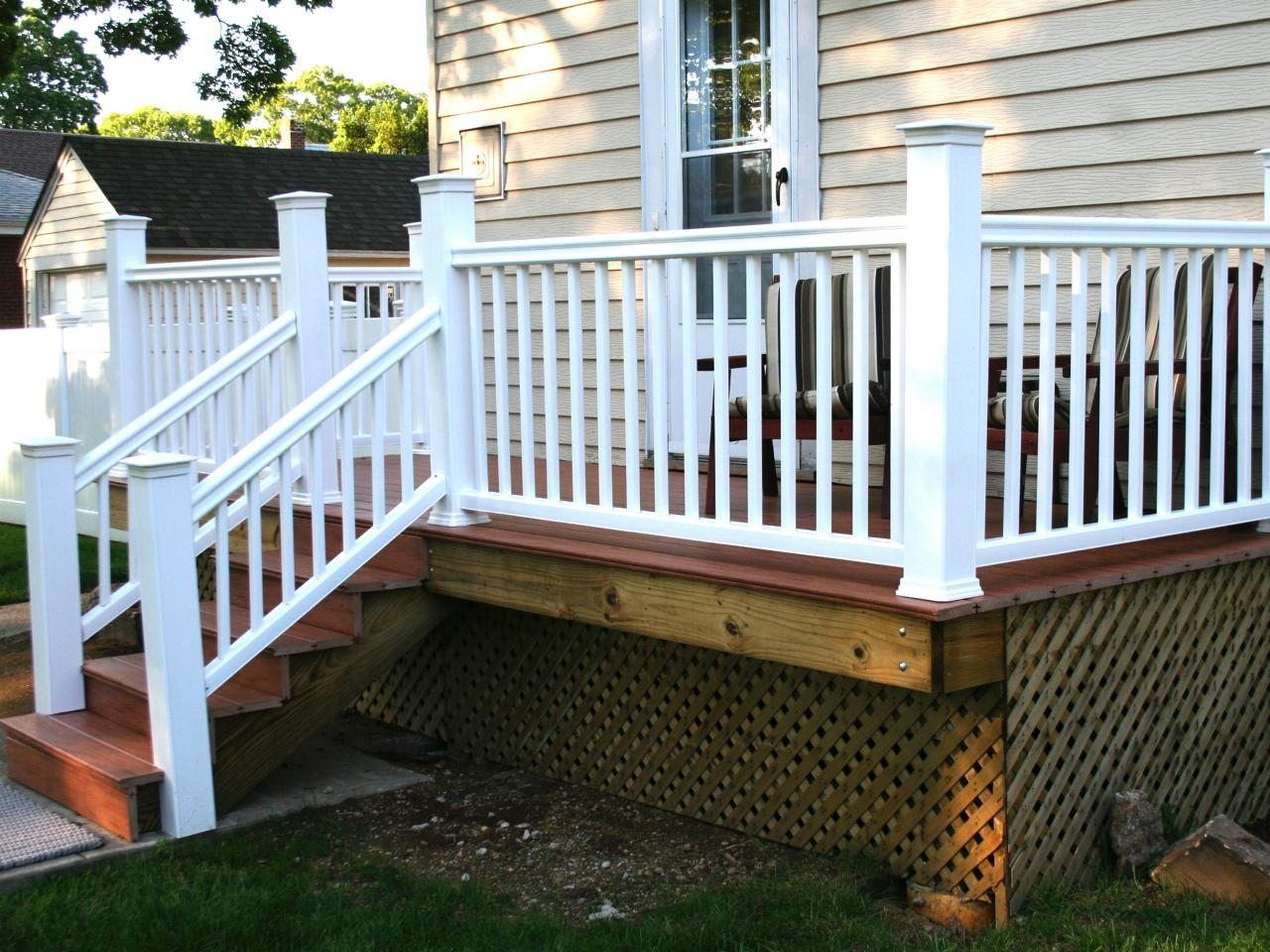 A white deck with stairs leading up to it