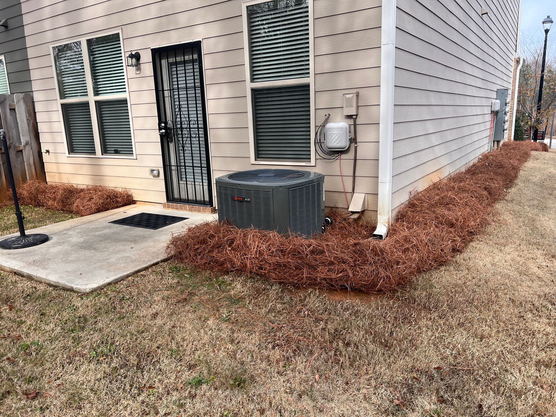 A house with a large air conditioner on the side of it.