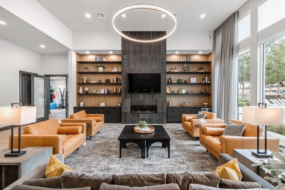 a clubhouse room filled with furniture and a fireplace at Marquis at Crown Ridge in San Antonio, TX.
