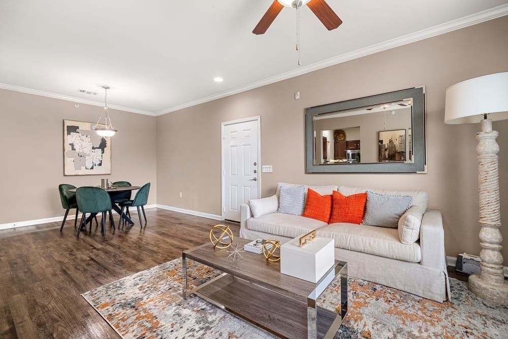 a living room with a couch, coffee table, and ceiling fan at Marquis at Crown Ridge in San Antonio, TX.