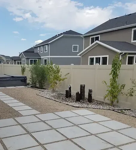A row of houses with a fence and a walkway in front of them
