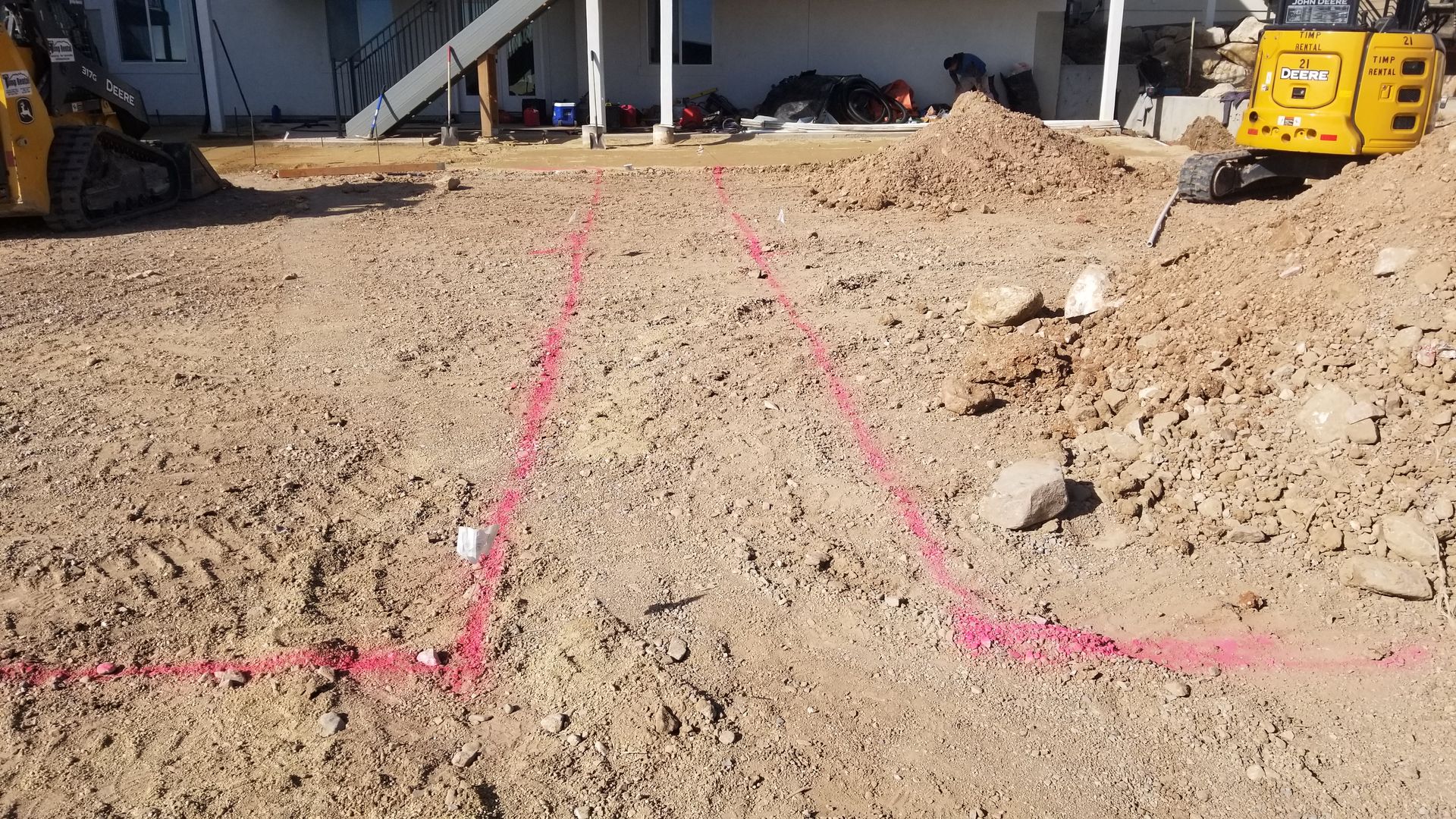 A construction site with a yellow bulldozer and a pile of dirt.