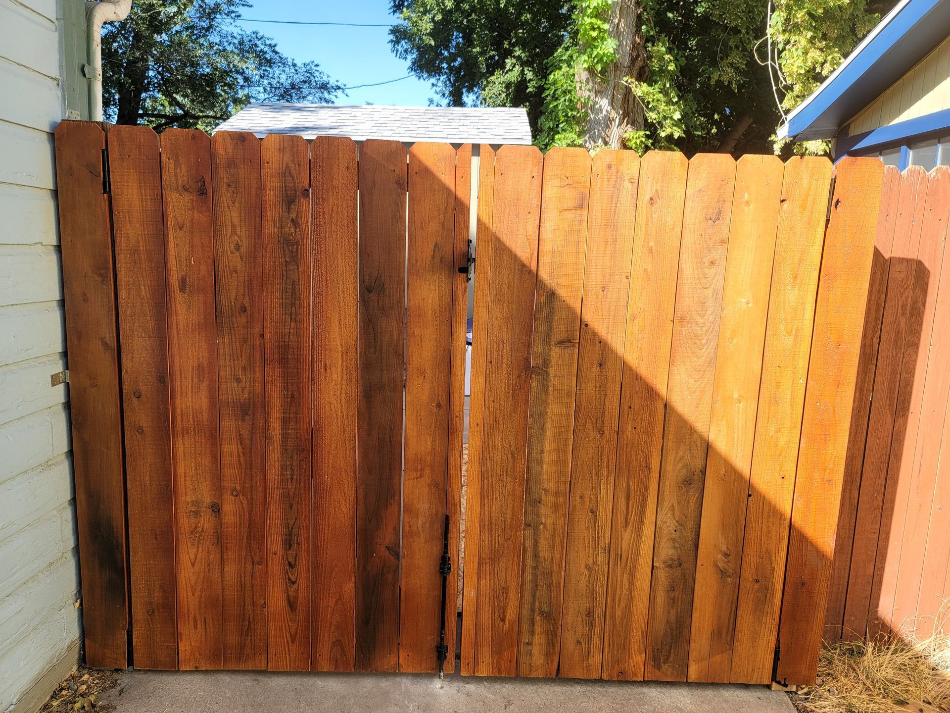 A wooden fence is sitting in front of a house