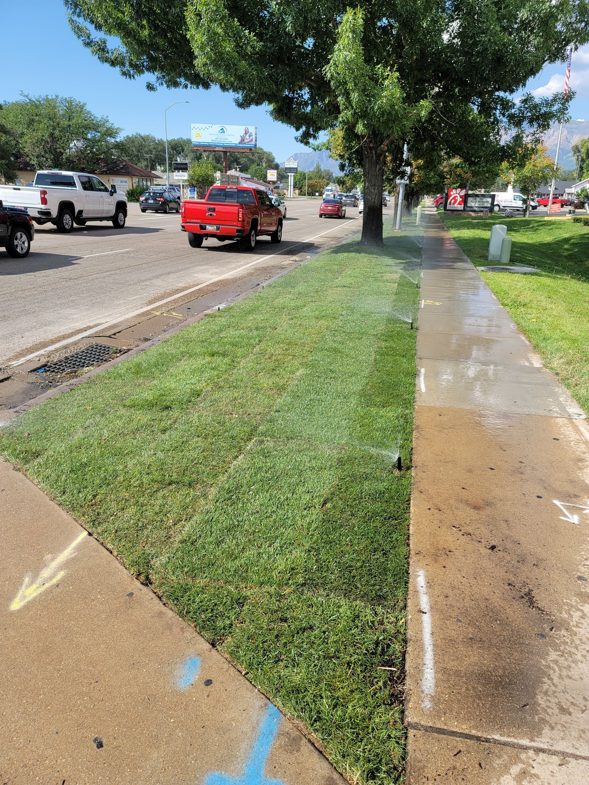 A red truck is parked on the side of the road