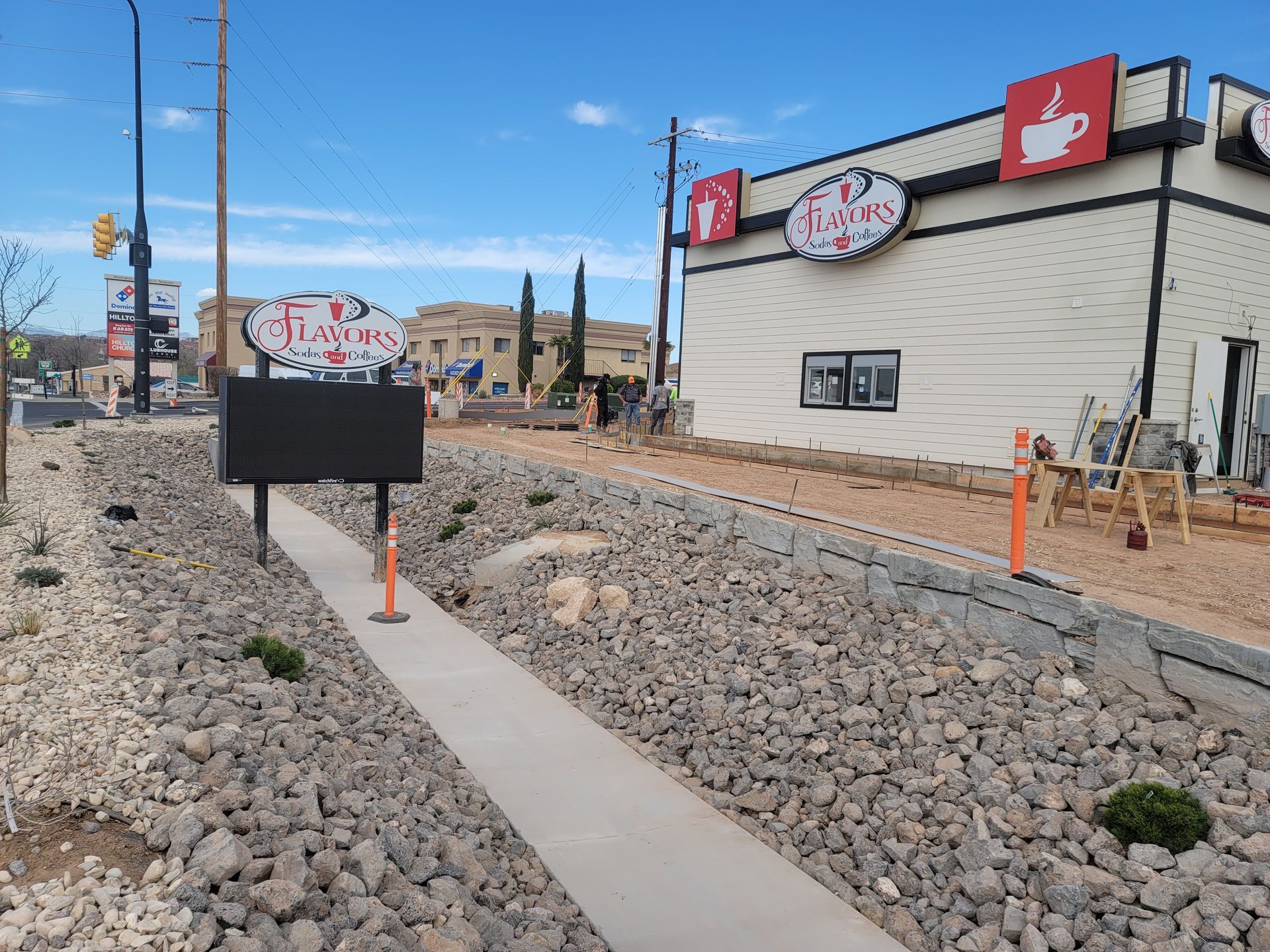 A walkway leading to a building with a sign on the side of it.