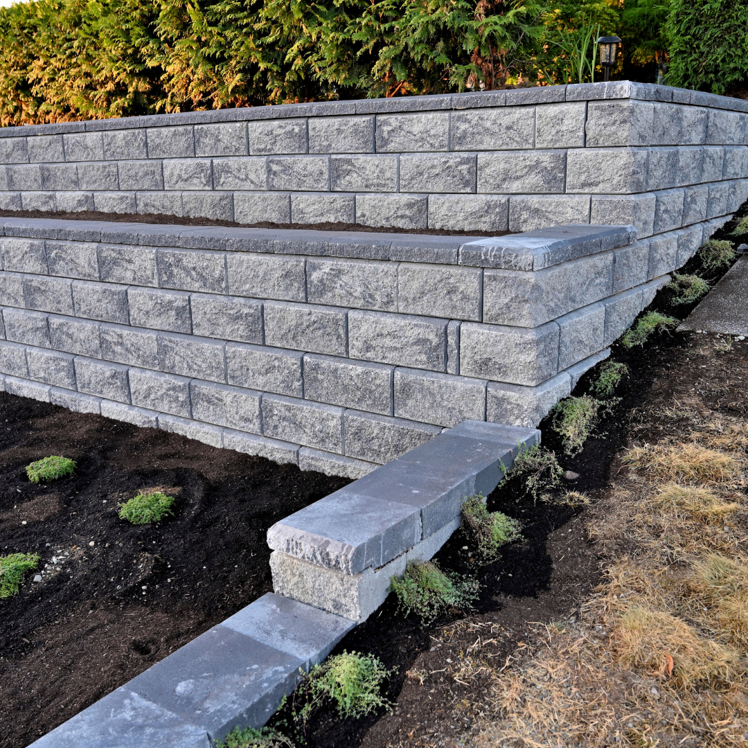 A brick wall with steps leading up to it in a garden.