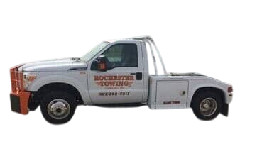 White Rochester Towing truck parked in a lot, ready to tow a vehicle.