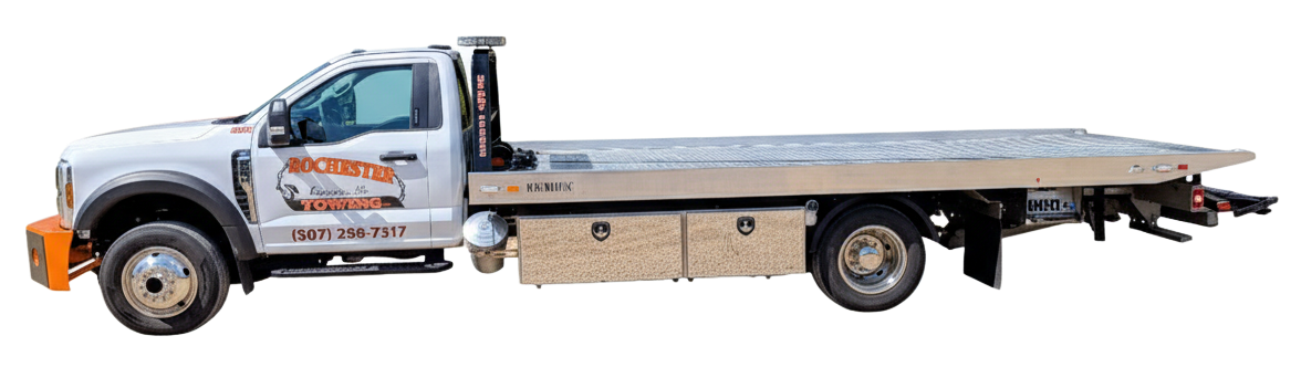 Red tow truck with boom extended, ready to tow.