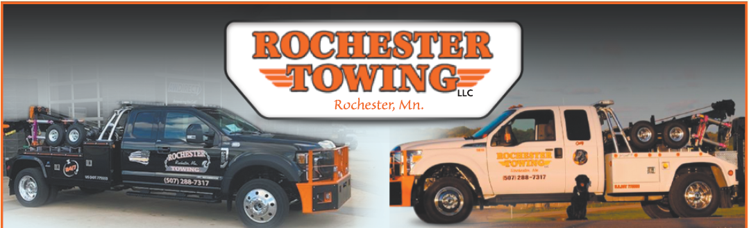 Two tow trucks, black and white, under 