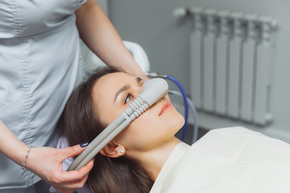 A woman is getting a facial treatment in a beauty salon.