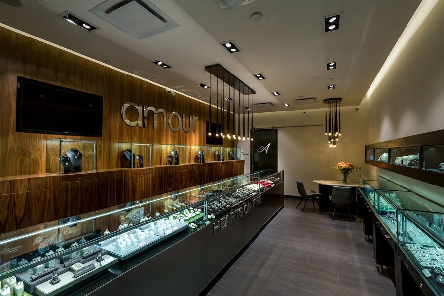 A jewelry store with lots of displays and a sign that says amour