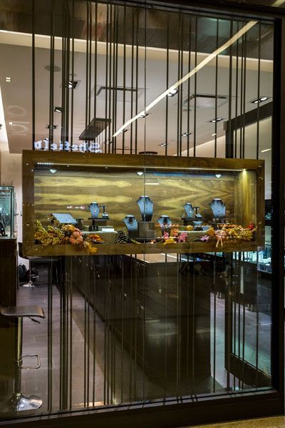 A store front with a display of jewelry in a glass case