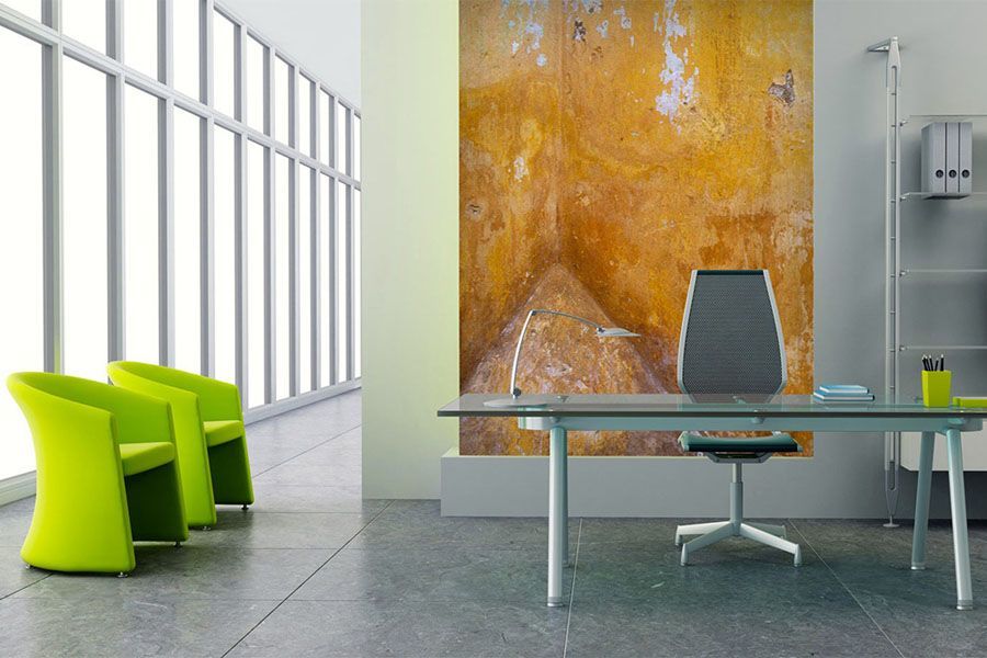 A room with a desk and chairs and a painting on the wall