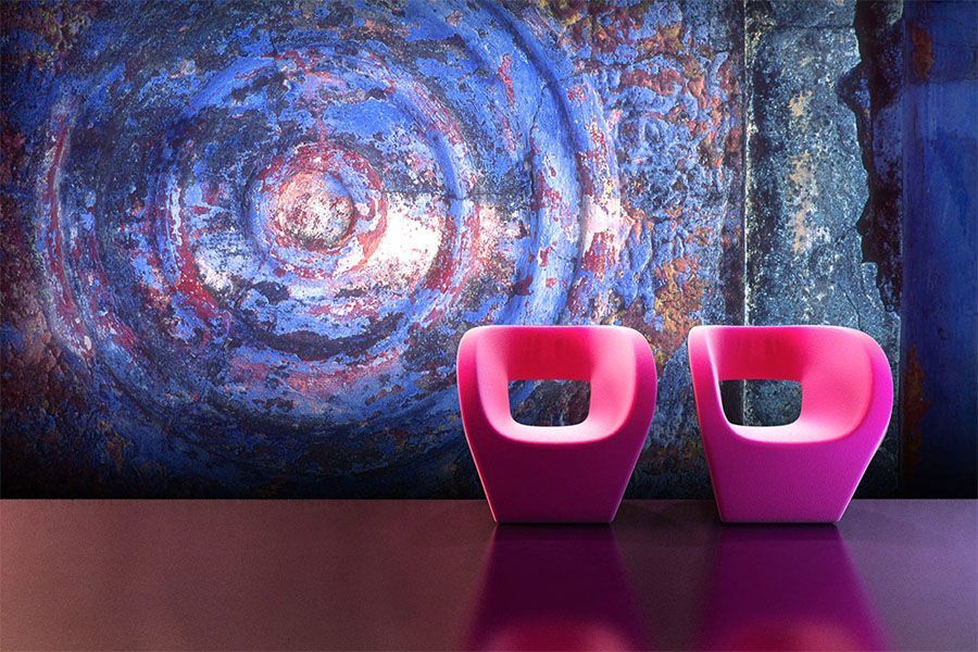 Two pink chairs are sitting on a table in front of a painting.