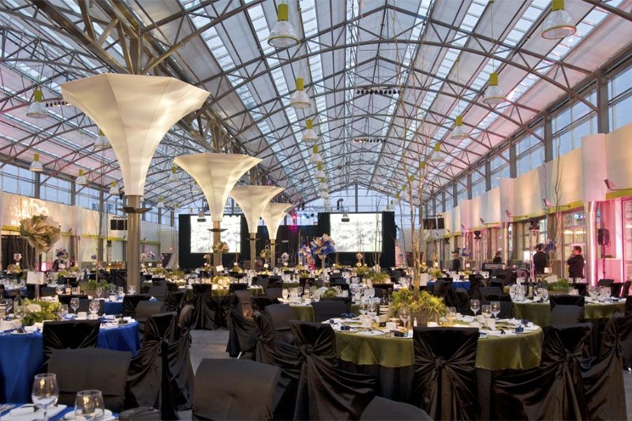 A large room with tables and chairs set up for a party