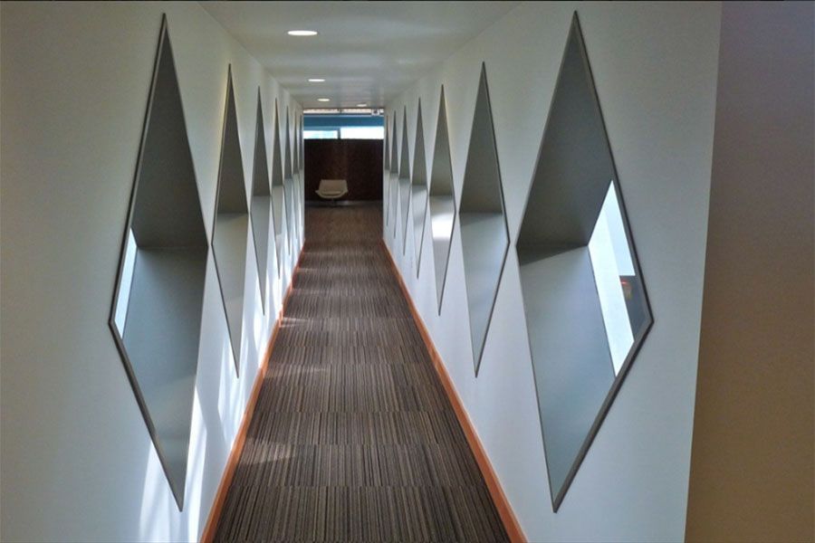 A long hallway with a lot of mirrors on the wall