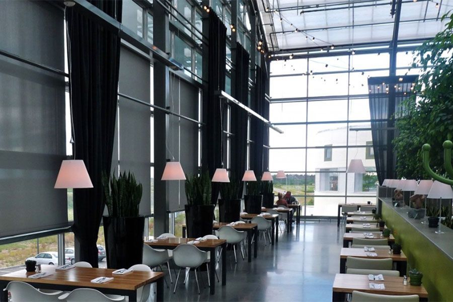 A restaurant with a lot of tables and chairs