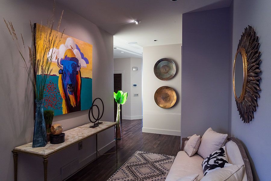 A living room with a couch and a painting on the wall