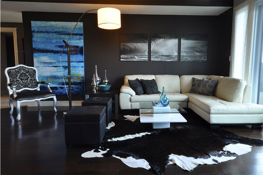 A living room with a couch a chair and a rug