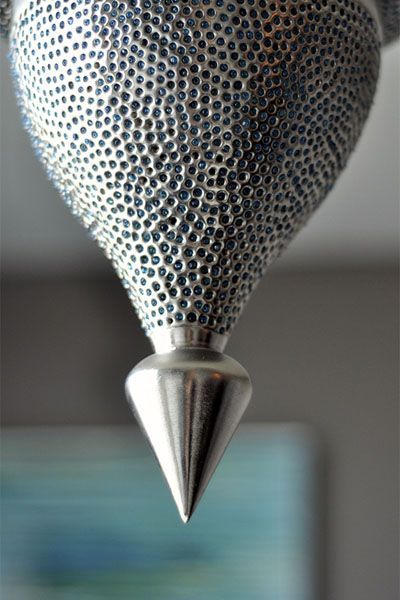 A close up of a metal object with a cone on top of it.