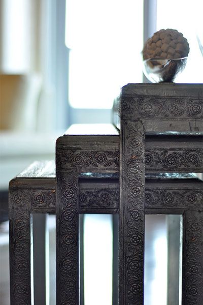 Two tables are stacked on top of each other in a living room.