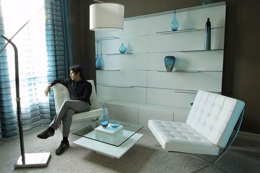 A man is sitting in a chair in a living room