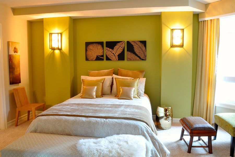 A bedroom with green walls and a bed