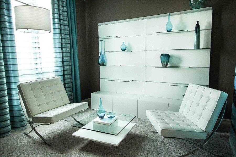 A living room with a couch and chairs and a coffee table