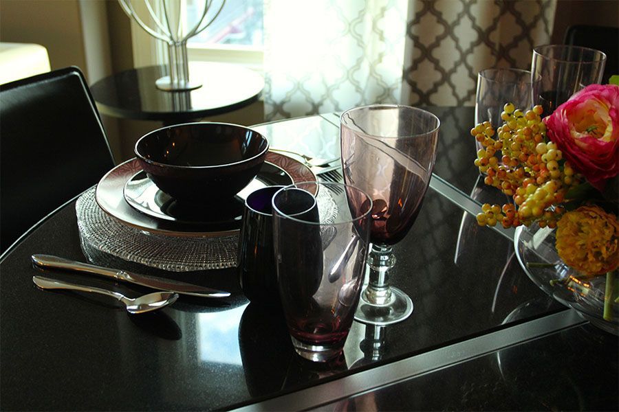 A table with plates bowls and wine glasses on it