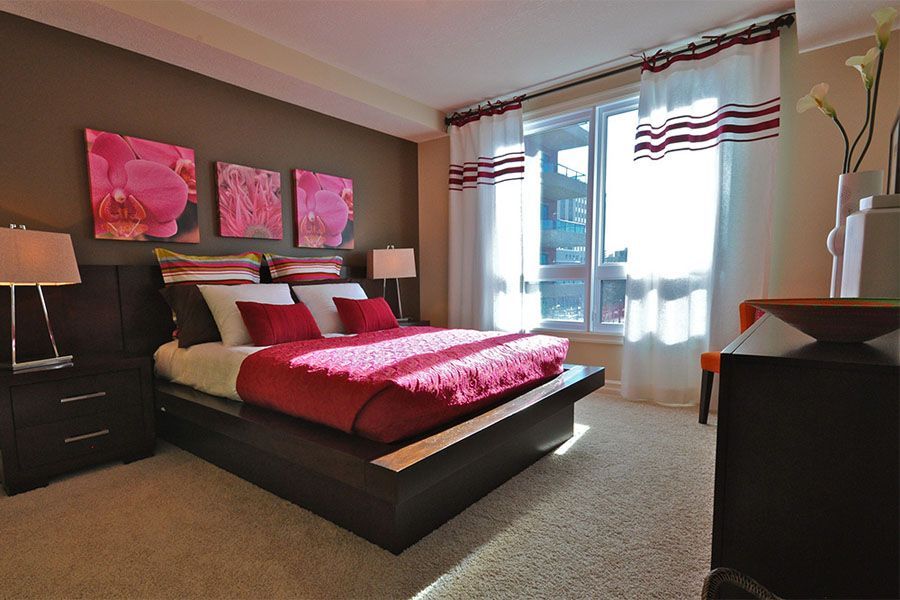 A bedroom with a large bed and a window