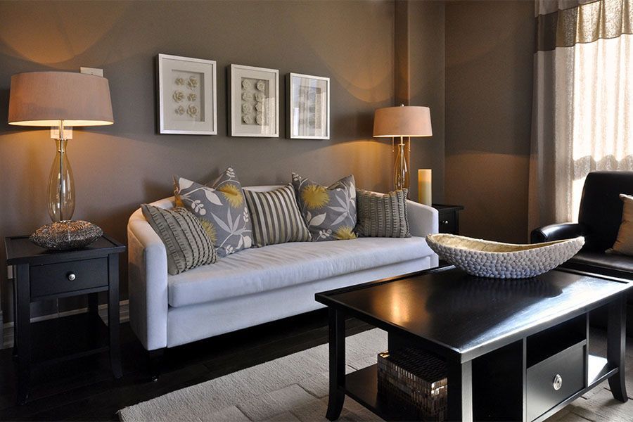A living room with a white couch and a black coffee table