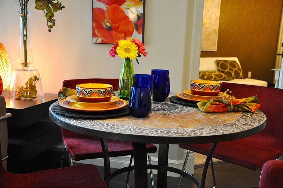 A dining room table with plates and bowls on it